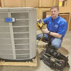 Josh owner of Castle Air Conditioning and Heating working on HVAC unit.