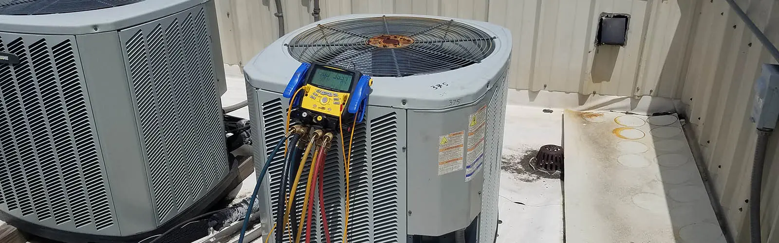 Rooftop Condenser that Castle Air Conditioning & Heating in providing maintenance on.