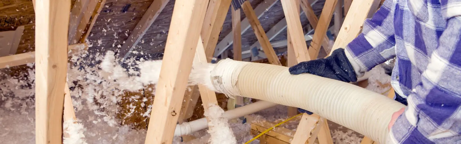 Blown-in fiberglass insulation in a Houston attic