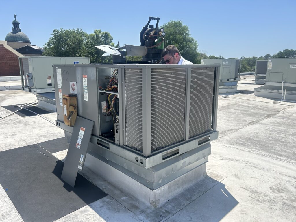 Castle AC & Heating technician servicing a commercial rooftop package unit in Houston