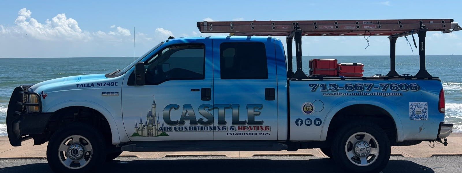 Castle Air Conditioning and Heating service truck parked on the Galveston Seawall with the Gulf of Mexico behind it
