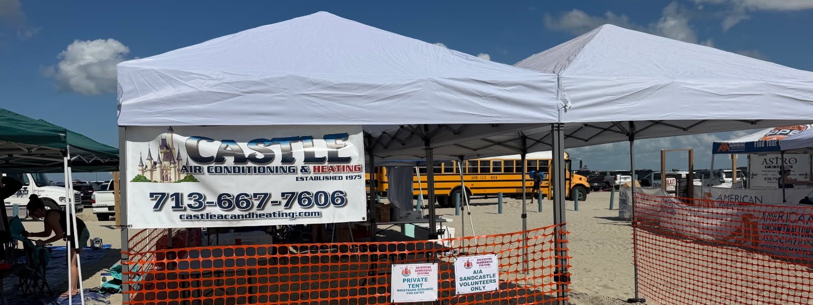 Castle Air Conditioning and Heating branded tent on the beach at the 2026 AIA Sandcastle Competition in Galveston