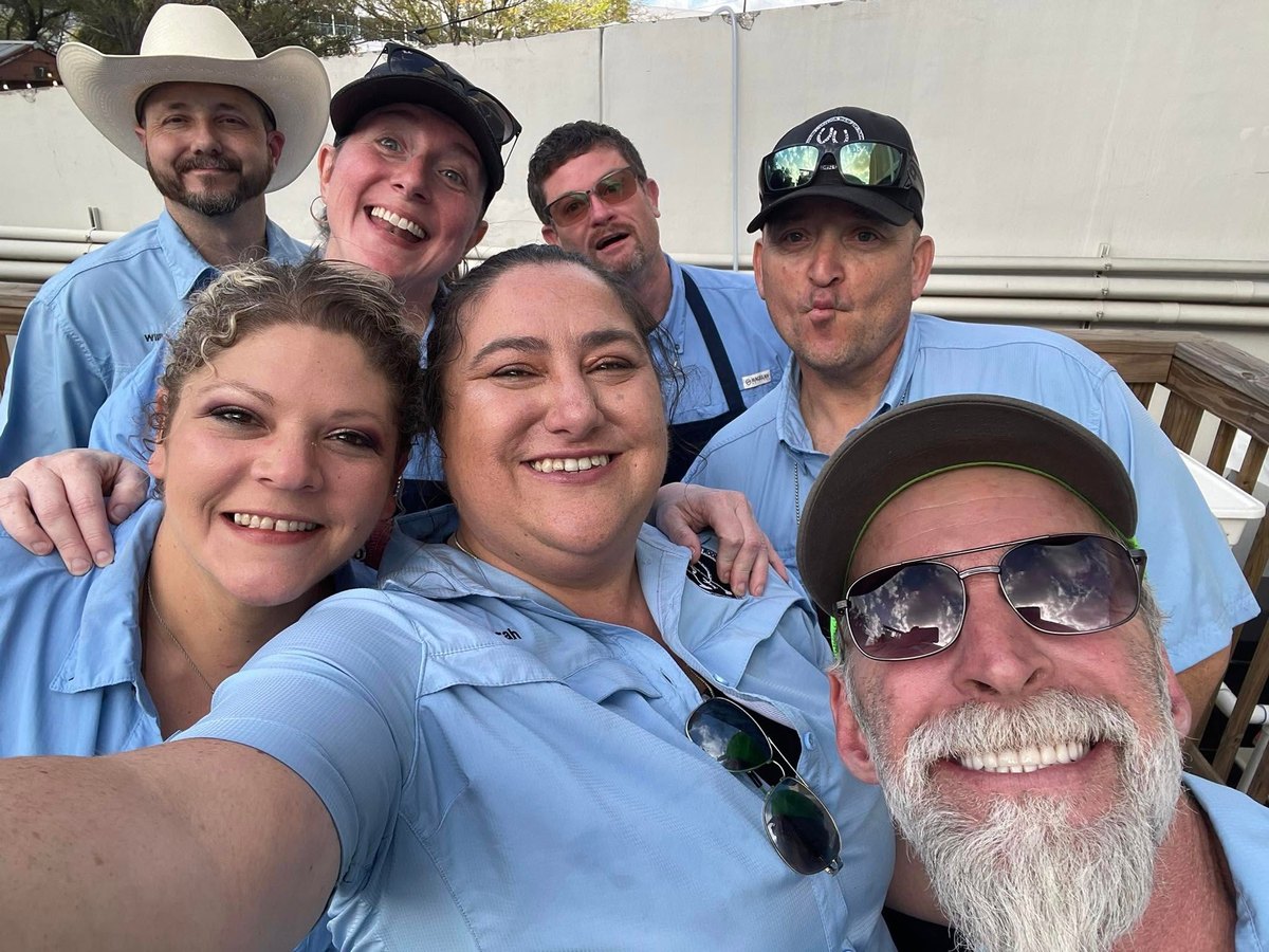 Volunteers from the Wine Committee cook team together during a shift at the Houston Livestock Show and Rodeo