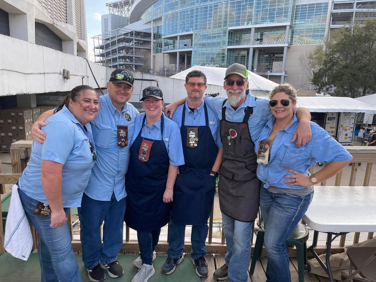 Castle Air Conditioning and Heating volunteers with their Wine Committee cook team at the Houston Livestock Show and Rodeo