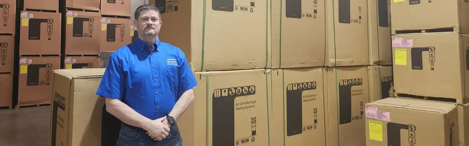 Castle Air Conditioning and Heating owner Josh Cartwright with central air conditioning systems at the Fulshear shop